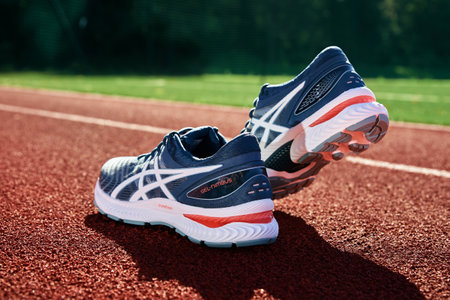 Asics Gel Nimbus running shoes at stadium track, Pair of Asics sport sneakers for jogging. Katy Wroclawskie, Poland - August 07, 2022のeditorial素材