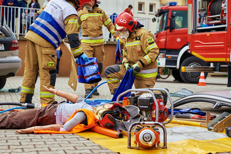 Rescuers provide first aid to the human dummy victim during rescue operation exercisesのeditorial素材