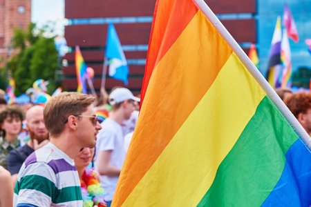People crowd have fun at gay pride parade with rainbow flags, March on city street in support of LGBT community. Wroclaw, Poland - June 11, 2022のeditorial素材