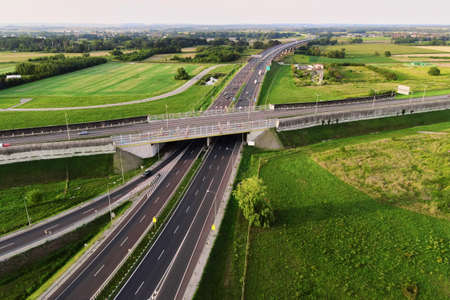 Aerial view of cars driving on round intersection in city, Transportation roundabout infrastructure,...