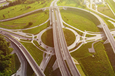 Aerial view of cars driving on round intersection in city, Transportation roundabout infrastructure,...