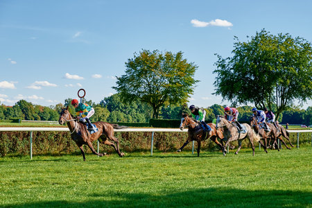 Running horse with jockey rider on green field. Wroclaw, Poland - September 5, 2021のeditorial素材