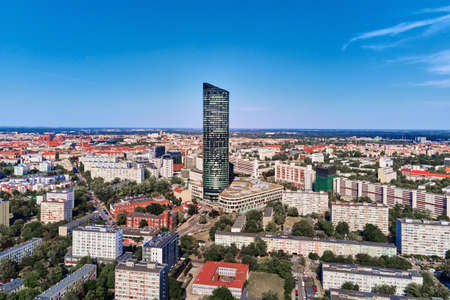 Drone flight over Wroclaw cityscape with Sky Tower skyscraper. Aerial view of modern european city...