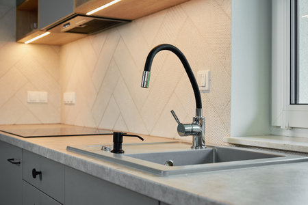 Modern kitchen with sink near window, Empty kitchen background with wooden countertop and cabinetsの写真素材