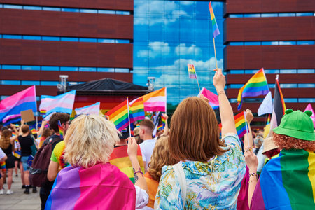 People crowd with LGBTQ rainbow flags on pride parade. Tolerance, diversity and gender identity concept. Wroclaw, Poland - June 11, 2022のeditorial素材