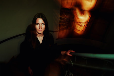 Creative woman portrait on dark background with blurred lights
