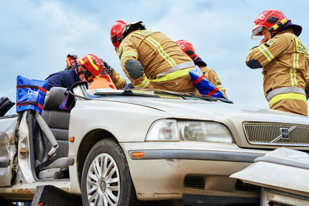 Firefighters during a rescue operation training. Rescuers unlock the passenger in car after accident. Katy Wroclawskie, Poland - May 28, 2022のeditorial素材