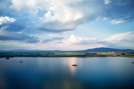 Aerial top view of beautiful landscape with large lake against mountains shapes at summer day. Mietkow lake near Wroclaw, Polandの写真素材