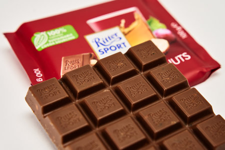 Bar of Ritter Sport chocolate. Rum raisins haselnuts flavor chocolate on white background. Wroclaw, Poland - December 28, 2022のeditorial素材
