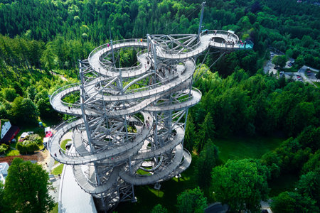 Sky Walk observation tower in Sweradow Zdroj, Poland. Tourist attraction in montains, aerial view. Panoramic view of nature landscape with green forestの写真素材