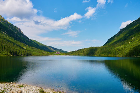 Amazing view on mountains range near beautiful lake at summer day. Tatra National Park in Poland. Panoramic view on Morskie Oko or Sea Eye lake in Five lakes valleyの写真素材
