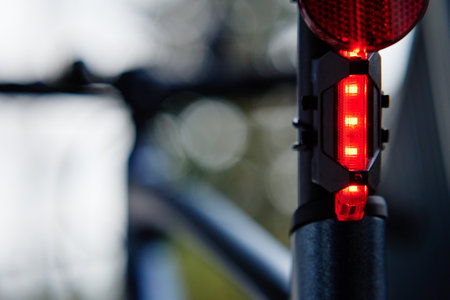 Glowing bicycle taillight. Red stop light for cyclist safety. Rear led light on bikeの写真素材