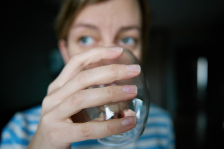 Woman drinks water, Close-up shot of woman drinking fresh clean water from glass, Quenching thirst, Lifestyle healthcare conceptの写真素材