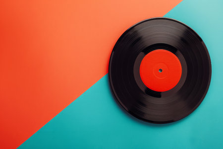Classic vinyl record on bright blue and orange background. Music composition with retro vinyl discの素材