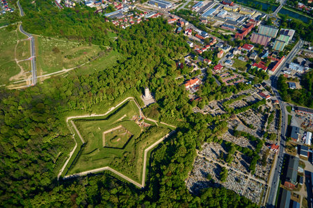 Aerial view of Prusy Fort in Nysa city on clear day, Star-shaped historical military fortress surrounded by lush greenery and the town in background. Tourist attraction in Polandの写真素材