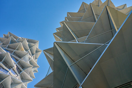 Abstract view of modern buildings with futuristic facade made of triangles. Modern residential...