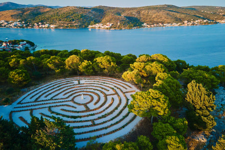 Panoramic view of islands in Adriatic Sea and hedge maze among forest trees at sunset. Lavender...