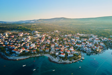 Aerial view of Adriatic sea coastline with coastal village and boats along shoreline. Panorama of...