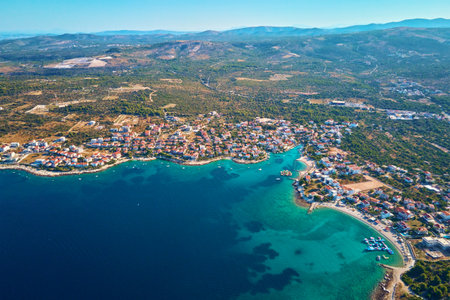 Islands in sea covered with lush greenery and houses, aerial view. Touristic place for summer vacation. Panoramic landscape of Adriatic sea coastline near Rogoznica town in Dalmatian region, Croatiaの写真素材