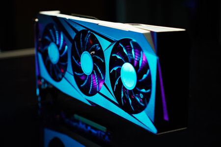 Close-up of high-performance graphics card with three cooling fans with neon lighting. Modern video...