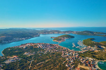 Islands in sea covered with lush greenery and houses, aerial view. Touristic place for summer vacation. Panoramic landscape of Adriatic sea coastline near Rogoznica town in Dalmatian region, Croatiaの写真素材