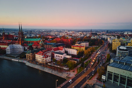 Aerial view of European city with Gothic churches and historic architecture in autumn season. St. John Cathedral on Ostrow Tumski at sunset. Cityscape panorama of Wroclaw, Polandの写真素材
