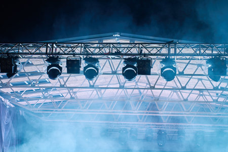 Close-up view of professional stage lighting mounted on metal truss. Bright spotlights at concert stage. Live music eventの写真素材