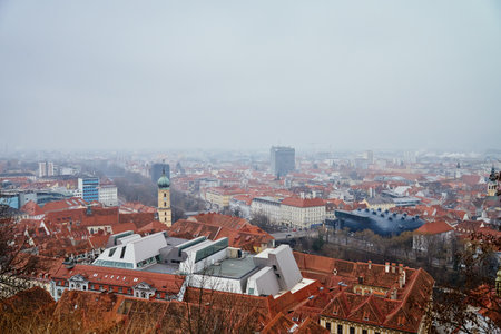 Graz cityscape on foggy day. Panoramic view of Graz, Austria with historical architecture. Streets with red roofed buildings in European city
