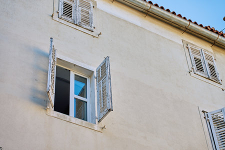 Old house with open glass window and wooden shutters. Building facade. Authentic Mediterranean architectureの写真素材