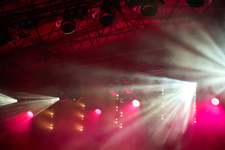 Stage with bright concert lighting, spotlights and smoke effects prepared for live music performance. Illumination for music eventの写真素材