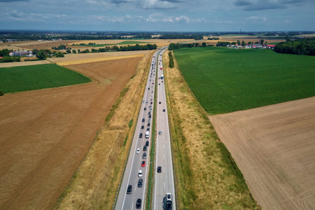 Aerial view of highway traffic with freight trucks and cars in motion. Concept of commercial transportation, delivery logistics and road infrastructureの写真素材
