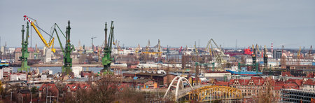 Panoramic view of shipyard with port cranes, industrial buildings and harbor infrastructureの写真素材