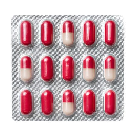 Blister pack with red and white capsules isolated on white background. Concept of medicine, treatment and healthcareの素材