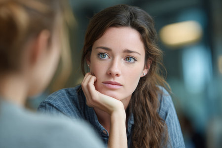 Close-up of female therapist listening to a patient during a mental health counseling session. Concept of psychological support, empathy and communicationの素材