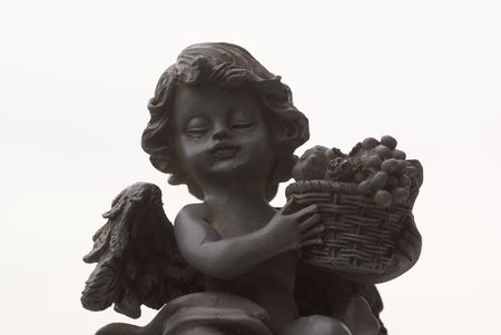 Isolated angel statue with fruit basket.の写真素材