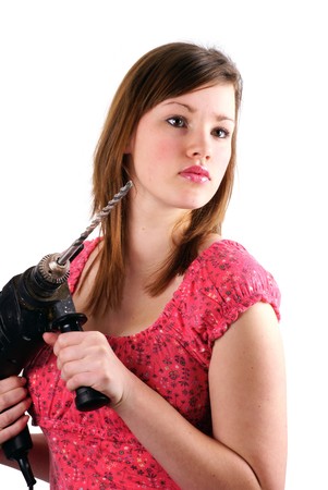DIY girl, ready to handle a hammer drill; isolated on white.の写真素材