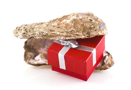 Oyster shells with little red jewelry box in between, isolated on white.の写真素材