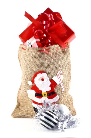 Bag full of christmas presents, isolated on white.の写真素材