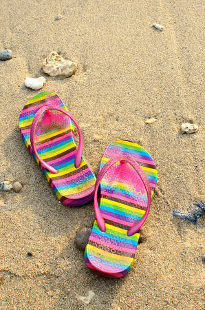 Beach sandals on the seashoreの写真素材