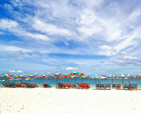 Beach chairs and colorful umbrella on the beach in sunny day, Phuket Thailandの写真素材