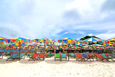Beach chairs and colorful umbrella on the beach in sunny day, Phuket Thailandの写真素材