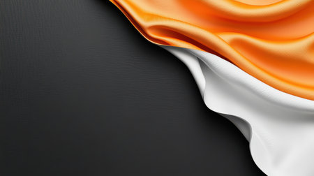 This image showcases elegant waves of orange and white fabric draped over a dark surface, creating a striking contrast and an inviting atmosphere.の素材