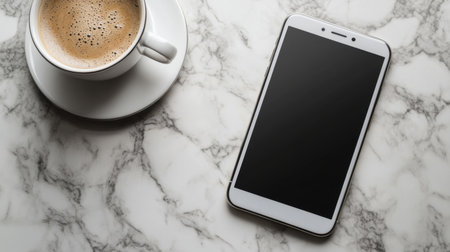 A blank smartphone screen on a marble counter with a coffee cupの素材
