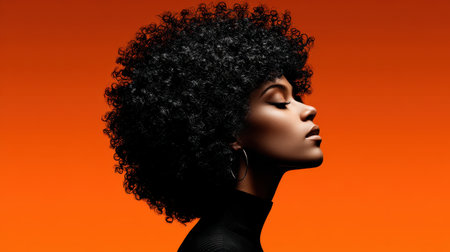 This captivating image features a woman with beautiful curly hair posed against a vibrant orange background, highlighting her elegance and confidence.の素材