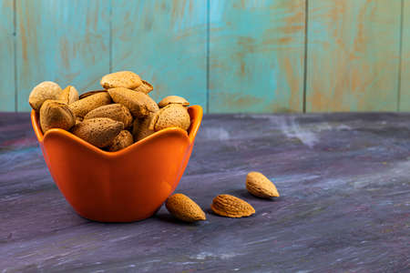 almonds with shells in red dishes. High quality photoの写真素材