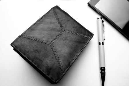 Cellular phone and black leather walletの写真素材