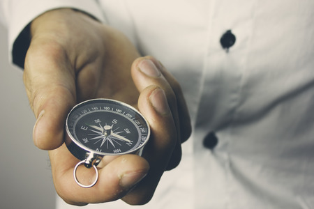 Businessman with a compass holding in handの写真素材