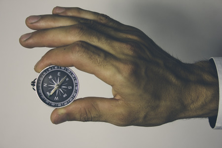 Businessman with a compass holding in handの写真素材