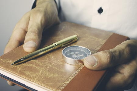 businessman holding diary in hands and hangsの写真素材