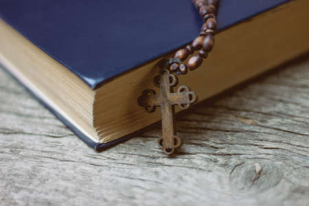 cross with a book on the tableの写真素材